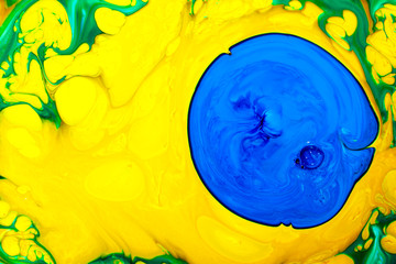 Abstract yellow multicolored background green blue view macro paint acrylic underwater ultra drop blob drip