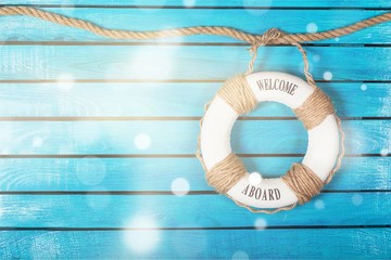 Lifebuoy on blue wooden background with place for text
