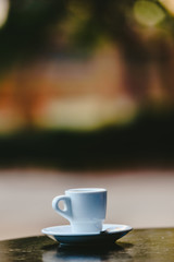 White coffee cup with defocused background and free space for text.