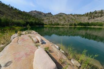 Summer landscape with lake and rocks
