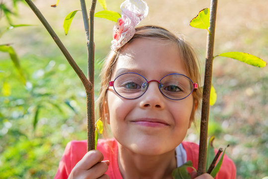 Little girl with glasses in nature