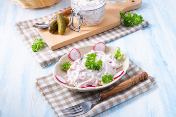 delicious homemade meat salad with mayonnaise and cucumber