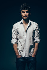 Obraz premium stylish handsome man posing in white shirt isolated on dark grey