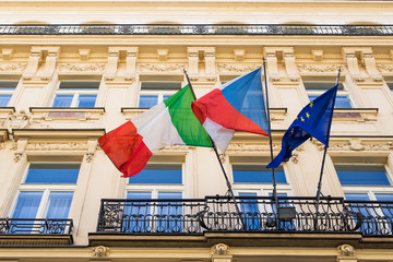 italian and european flags and other flag on a balcony