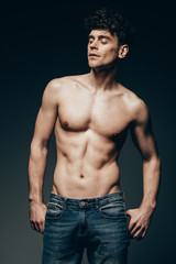 Fototapeta premium sexy shirtless muscular man in jeans posing isolated on dark grey