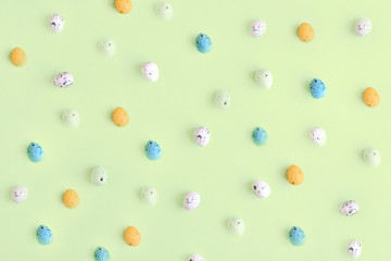 Small Easter eggs on a yellow background, top view