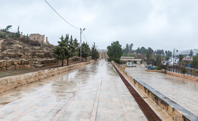 The road leading from Hadrians Gate to South Gate in the ruins of the great Roman city of Jerash -...