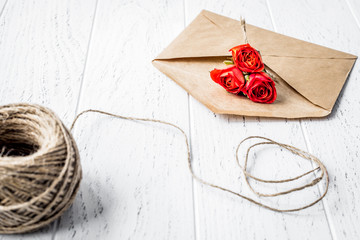 envelope and flowers on wooden background mock up
