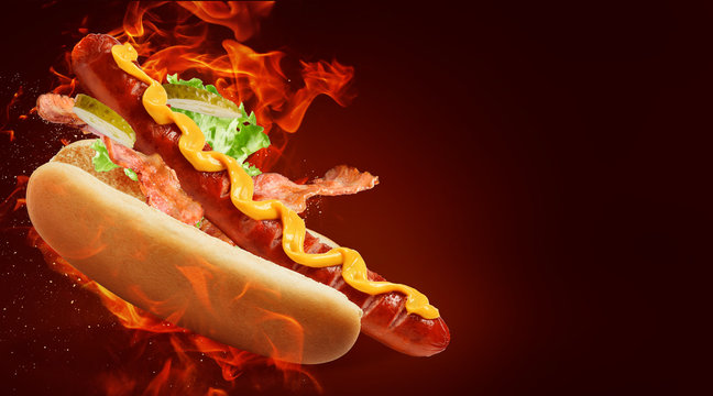 hot dog with big sausage and mustard on fire background