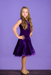 Ballroom dancewear fashion concept. Kid dancer satisfied with concert outfit. Girl cute child wear velvet violet dress. Clothes for ballroom dance. Kids fashion. Kid fashionable dress looks adorable