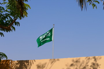 The flag of the Kingdom of Saudi Arabia waving in the historic Diriyah