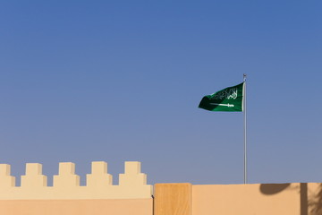 The flag of the Kingdom of Saudi Arabia waving in the historic Diriyah