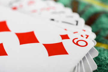 selective focus of playing card with diamonds suit in deck