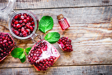 sliced pomegranate on wooden background top view