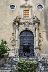Fototapeta na wymiar Carved Baroque portal of Santo Stefano Church also known as church of Purgatory (Chiesa del Purgatorio, 1668) at Piazza Giovanni in Cefalu, Sicily, Italy.