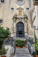 Fototapeta na wymiar Carved Baroque portal of Santo Stefano Church also known as church of Purgatory (Chiesa del Purgatorio, 1668) at Piazza Giovanni in Cefalu, Sicily, Italy.