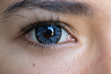 Close up of beautiful woman eye and contact lens. 