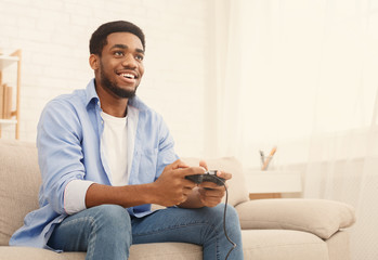 Young man playing video games at home