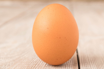 Chicken egg on a wooden table. Close up.