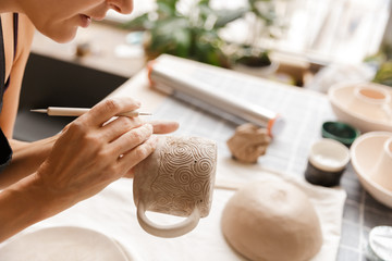 Obraz na płótnie Canvas Close up of a woman making ceramic and pottery