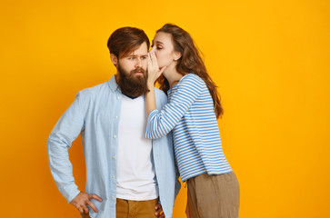 couple of emotional people man and woman on yellow background.
