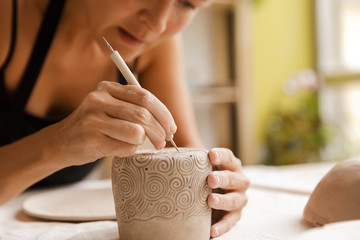 Close up of a woman making ceramic and pottery