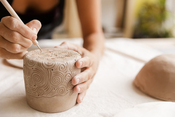 Close up of a woman making ceramic and pottery - obrazy, fototapety, plakaty