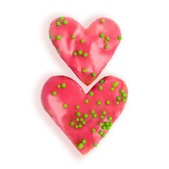 Valentine heart shaped strawberry cakes decorated with green sugar balls isolated on white background. Flat lay. Top view