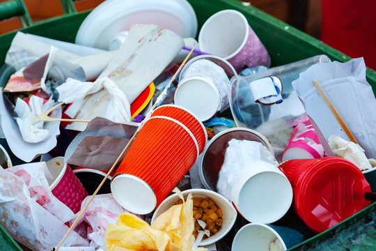 Trash can filled with waste.