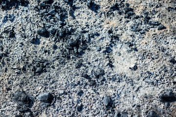 Extinguished and cooled down fire made of wood. Ash and charcoal cooled after burning. Background of coals and ash.