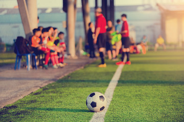 soccer ball at touchlines on artificial turf with blurry of soccer players