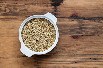 green uncooked buckwheat in bowl