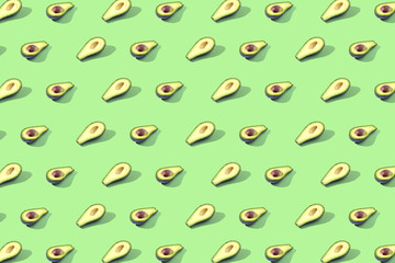 Many halves of avocado, pattern, banner. Preparation of a bright background, green mint pastel color.