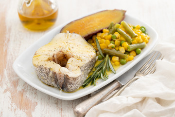 boiled fish with vegetables on white dish
