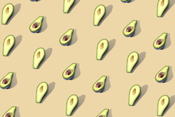 Many halves of avocado, pattern, banner. Workpiece bright background, pastel yellow color.