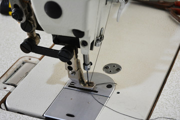 Sewing machine on table in tailor's workshop
