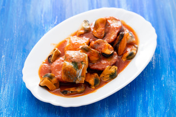 fish with seafood and sweet potato on white dish