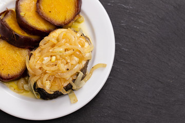 boiled fish with onion and sweet potato on white dish