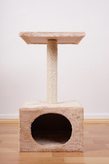 small cat tree or tower with hideaway scratching post and lookout platform                           
