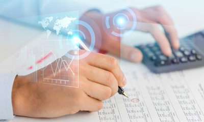 Businessman using a calculator to calculate the numbers