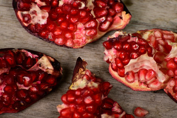 Juicy pomegranate on wooden background