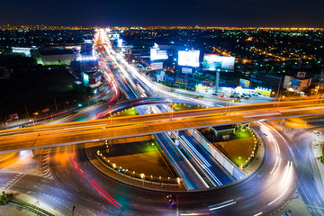 Fototapeta na wymiar Night light of vehicle movement traffic junction city road
