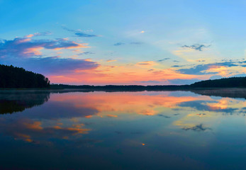 Fototapeta na wymiar Beautiful panoramic view of the sunset over Lemiet lake in Mazury district, Poland. Fantastic travel destination.