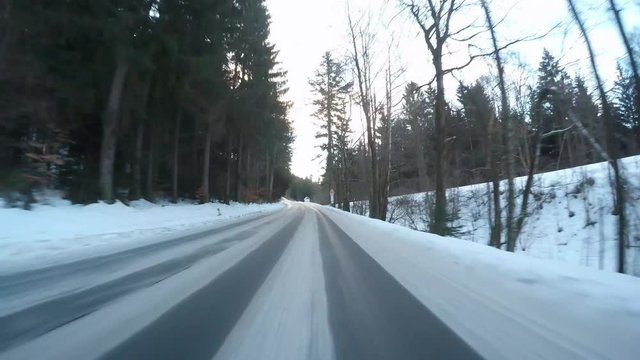Snowy road. Dangerous situation from winter traffic in National park Sumava, Czech Republic, Europe. Video from action camera with engine sound.