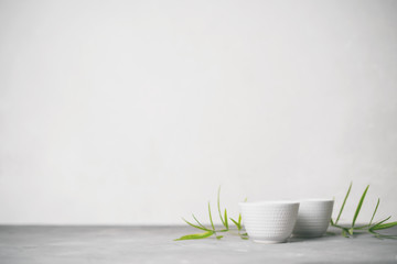Asian food background set with  green tea cups with free space for text on white background.