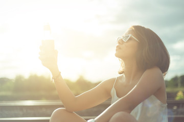 A beautiful girl drinking a whisky between travel alone for her vacation time.