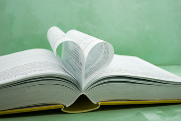 pages of a book curved into a heart shape