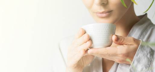 Close view a beautiful woman holding teacup. Asian food theme background with tea ceremony. Brewing and Drinking tea.