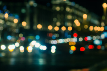 Blurred background - night street with lights of houses and cars.