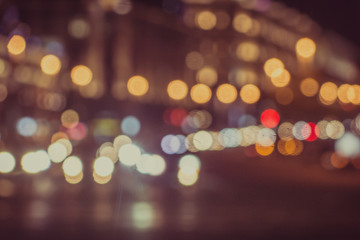 Blurred background - night street with lights of houses and cars.